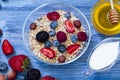 Greek yogurt granola and berry mix. Top view. Delicious healthy muesli with raspberry, blueberry, strawberry, hazelnut Royalty Free Stock Photo