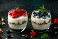 Greek yogurt with granola, raspberry, blueberry in glass jar. Healthy breakfast food or snack Royalty Free Stock Photo