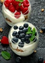 Greek yogurt with granola, raspberry, blueberry in glass jar. Healthy breakfast food or snack Royalty Free Stock Photo