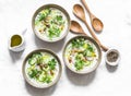 Greek yogurt soup with cucumber, radish, cilantro and nut on a light background, top view. Delicious vegetarian food. Flat lay