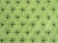 Green abstract background with symmetrical upholstered buttons on fabrics. Royalty Free Stock Photo