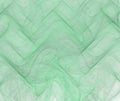 Green abstract background with thin fabric or smoke texture. Turquoise ordered fractal waves pattern, with light corner.