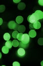 Green abstract Christmas blurred luminous background. Defocused artistic bokeh lights image Royalty Free Stock Photo