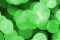 Green abstract Christmas blurred luminous background. Defocused artistic bokeh lights image Royalty Free Stock Photo