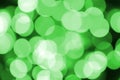 Green abstract Christmas blurred luminous background. Defocused artistic bokeh lights image Royalty Free Stock Photo