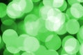 Green abstract Christmas blurred luminous background. Defocused artistic bokeh lights image Royalty Free Stock Photo