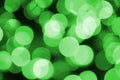 Green abstract Christmas blurred luminous background. Defocused artistic bokeh lights image Royalty Free Stock Photo