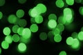 Green abstract Christmas blurred luminous background. Defocused artistic bokeh lights image Royalty Free Stock Photo