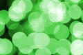 Green abstract Christmas blurred luminous background. Defocused artistic bokeh lights image Royalty Free Stock Photo