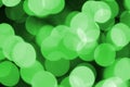 Green abstract Christmas blurred luminous background. Defocused artistic bokeh lights image Royalty Free Stock Photo