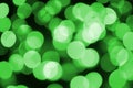 Green abstract Christmas blurred luminous background. Defocused artistic bokeh lights image Royalty Free Stock Photo