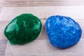 Green adn blue slime on a wooeden table