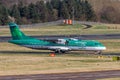 Green Aer Lingus plane taking flight from an airport flight strip