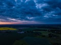 Green Agricultural Meadows with Dramatic Clouds over them on Sunset