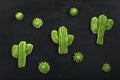 Green air cookies in the form of cactus. French dessert meringe on black table