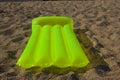 Green airbed lying on a sand Royalty Free Stock Photo