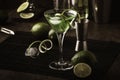 Green alcoholic cocktail monk with dry gin, vermouth, liquor, lime zest and ice, bar tools, dark background