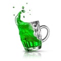 Green alcoholic drink splash in a beer mug on a white.