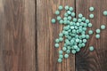 Green algae pills - chlorella, spirulina on a wooden background. Healthy green food supplement concept Royalty Free Stock Photo