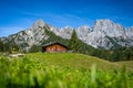 Green alpine meadow with wooden hut in front of impressive mountain peaks, Salzburg, Austria, Europe Royalty Free Stock Photo