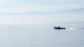 A boat speeding in the still waters of a lake