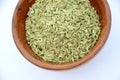 The green anise in the wooden bowl isolated in white background