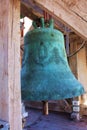 Green antique big bell in a village chapel. Beautiful Christian architecture, religion and traditions. Croatia, the city of Zadar Royalty Free Stock Photo