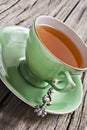 Green antique tea cup with healthy organic tea Royalty Free Stock Photo