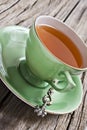 Green antique tea cup with healthy organic tea