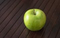 Green Apple alone on too of wood table Royalty Free Stock Photo