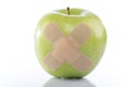 Green apple with a band-aid Royalty Free Stock Photo