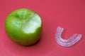 Green apple with bite and a dental splint