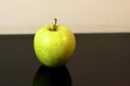 Green apple black background reflection Royalty Free Stock Photo