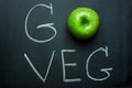 Green Apple on Black Chalkboard Hand Lettering Go Veg. Vegan Vegetarian Concept Healthy Diet Superfood.