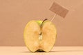 Green Apple with blank price tag or empty paper panel Royalty Free Stock Photo