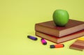 Green apple and books