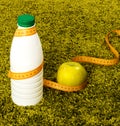 Green apple and bottle of yogurt. Royalty Free Stock Photo