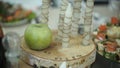 Green apple, cinnamon, walnut and a candle. Green apple and candles. Green apple candle Royalty Free Stock Photo