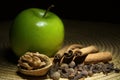 Green apple, cinnamon and walnut on the table Royalty Free Stock Photo