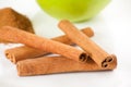 Green apple, cinnamon on white plate Royalty Free Stock Photo
