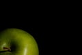 Green apple in contrast light on the side Royalty Free Stock Photo