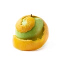 Green apple covered with orange peel Royalty Free Stock Photo