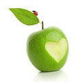 Green apple with cut heart and ladybird Royalty Free Stock Photo