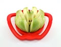 Green apple cut into slices on slicer tool machine. Royalty Free Stock Photo