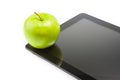 Green apple on digital tablet pc on white background with space for text Royalty Free Stock Photo