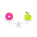 Green apple and doughnut on scales. Diet concept. Healthy and unhealthy food