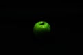 Green apple with drops of water on a black background Royalty Free Stock Photo