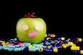 GREEN APPLE WITH EYES AND NOSE WITH MEDICINE Royalty Free Stock Photo