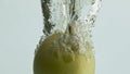 Green apple falling water closeup. Tasty season fruit flowing transparent liquid Royalty Free Stock Photo