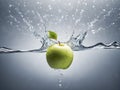 Green apple falling into water with splash and